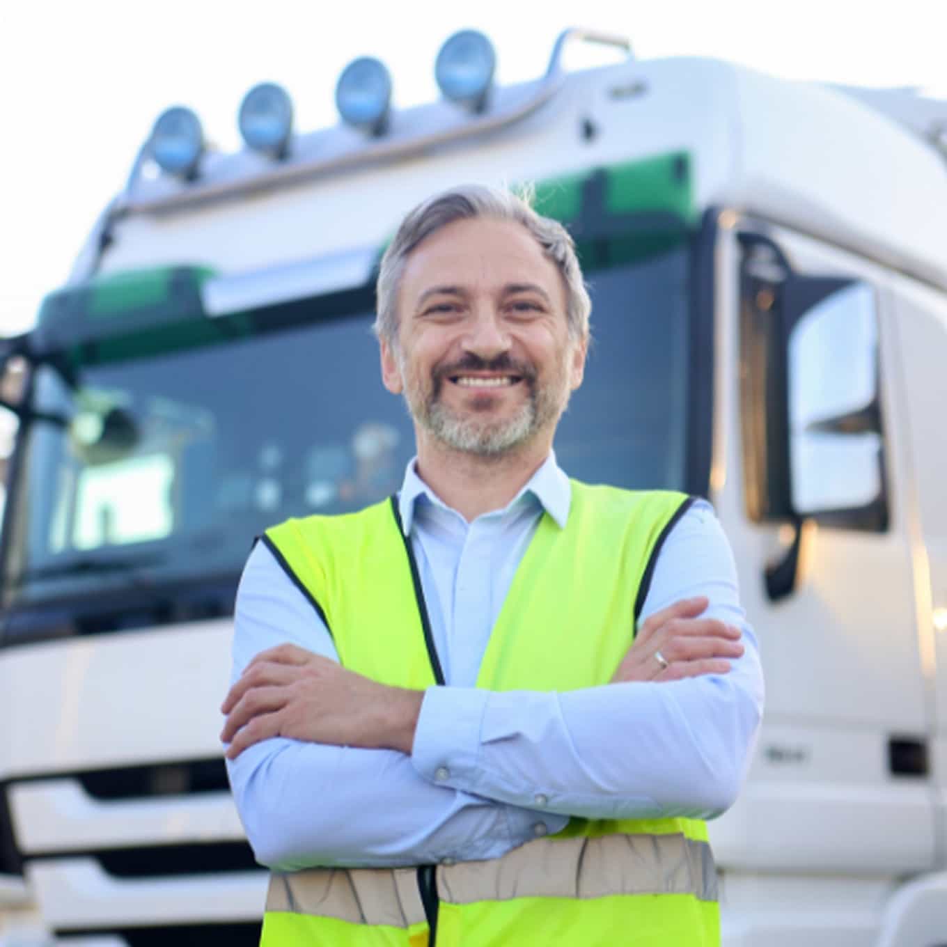 FINCO Logistics transport professional standing in front of heavy vehicle
